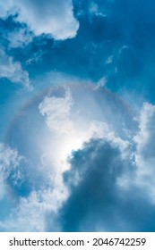 Full Circle Rainbow Or Halo Around The Sun On The Cloudy Blue Sky