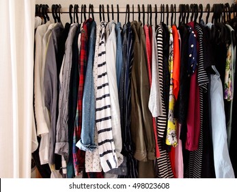 Full Clothes Rail In A Womans Closet