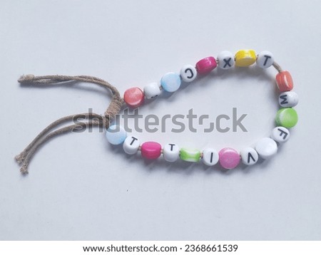 Full color alphabet bracelet accessories with a white background.