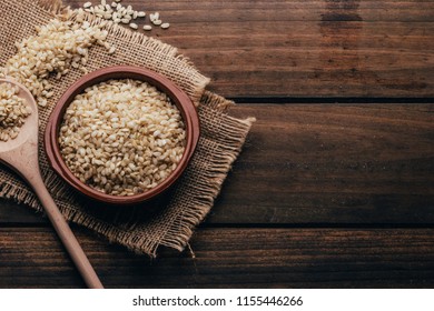 Full Container With Brown Rice, Rustic Style