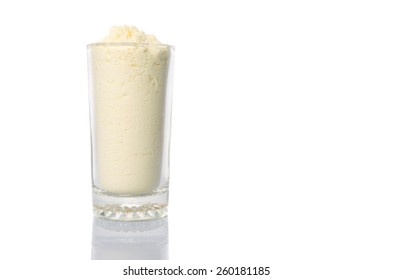 Full Cream Milk Powder In A Glass Over White Background