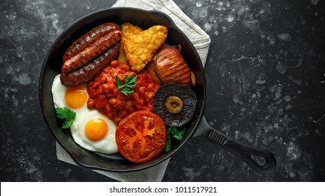 Full English Breakfast With Bacon, Sausage, Fried Egg, Baked Beans, Hash Browns And Mushrooms In Rustic Skillet, Pan.