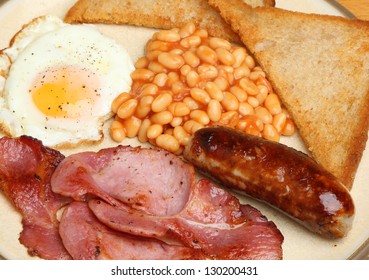 Full English Breakfast With Bacon, Sausage, Egg, Baked Beans And Fried Bread.