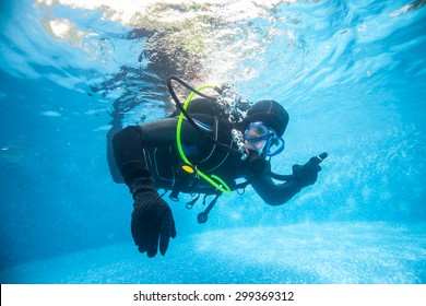 Full Equiped Diver In Swimming Pool