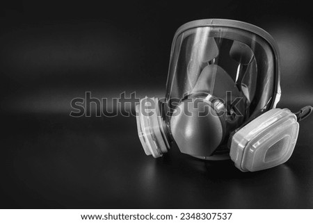 Full face gas mask respirator for personal protection of eyes and respiratory organs from harmful vapors, gases, radioactive dust. Black and white. Selective focus. work equipment. medicine.