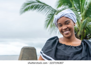 Full face portrait of a Nicaraguan Caribbean Afro-descendant woman smiling and looking at camera with copy space