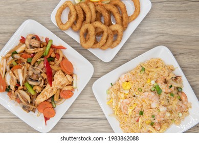 Full Feast Of Spicy Thai Food On The Wooden Table With The Featured Dish Being The Star Shaped Fried Rice With Shrimp.