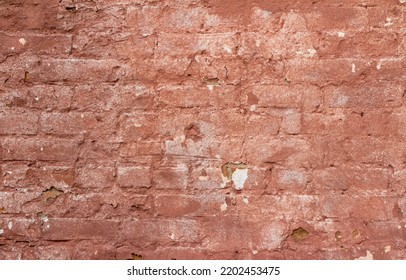 Full Frame Abstract Texture Background Of A Shabby Chic Old Rose Color Painted Clay Brick Wall With An Artsy Deteriorating Appearance