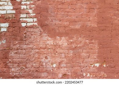 Full Frame Abstract Texture Background Of A Shabby Chic Old Rose Color Painted Clay Brick Wall With An Artsy Deteriorating Appearance