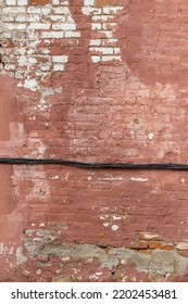 Full Frame Abstract Texture Background Of A Shabby Chic Old Rose Color Painted Clay Brick Wall With An Artsy Deteriorating Appearance, With View Of Electrical Wiring