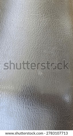 Full frame abstract texture background of a dark brown or black synthetic leather surface