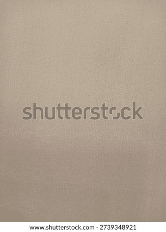 Full frame background of beige soft fabric texture. Neutral tan colored textile material with fine weave pattern for fashion or upholstery.