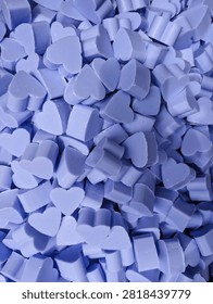 Full frame background of hand made purple lavender soap heart shaped bars for spa hygiene cosmetic skin care and Valentine gift theme.