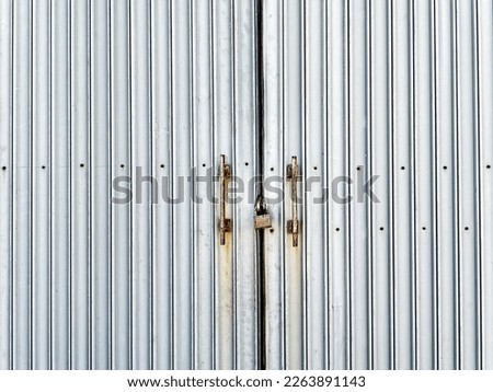 Full Frame Background of Locked Rusty Corrugated Metal Door