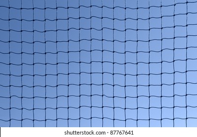 full frame background showing a dark netting in front of blue sky