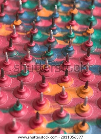 Full frame background of spiked massage pad with metallic pins, acupressure therapy and reflex zone reflexology concept for holistic wellness and pain management advertising