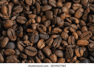 Full frame background texture of freshly roasted arabica coffee beans