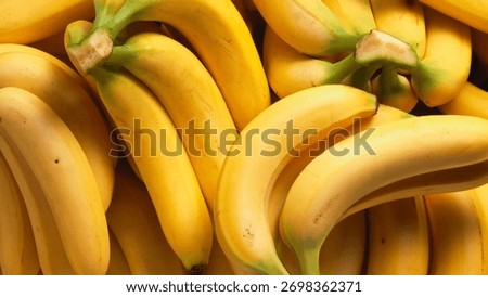 Full Frame Background Texture of Ripe Yellow Bananas in a Bunch - Close-up full frame of a bunch of ripe bananas.