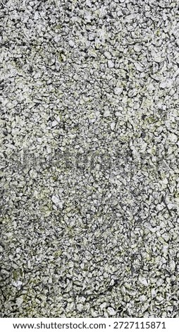 Full frame background texture of rough white gravel and crushed stone aggregate surface.