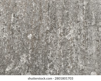 Full frame background texture of weathered rough concrete surface with grunge stains. A close-up view of a rustic unpainted concrete wall surface showing aged atmospheric grunge stains during daytime.