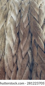 Full frame background of thick braided natural fiber mooring rope texture close up