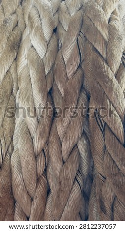 Full frame background of thick braided natural fiber mooring rope texture close up