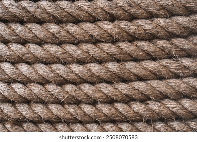 A full frame background of thick shipping rope tightly wrapped together and made from durable natural fibres such as Jute with copy space
