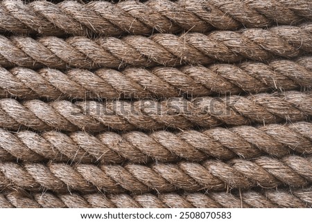 A full frame background of thick shipping rope tightly wrapped together and made from durable natural fibres such as Jute with copy space