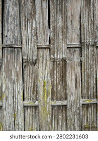 Full frame background of traditional rustic bamboo fencing or cottage wall panels.