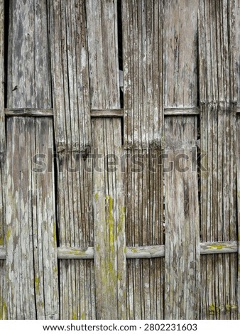 Full frame background of traditional rustic bamboo fencing or cottage wall panels.