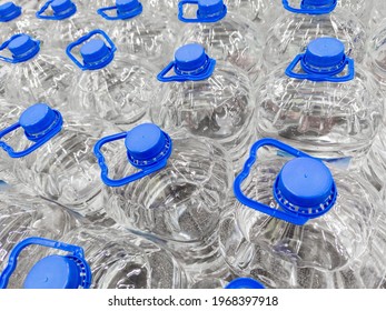 full frame background of transparent plastic 5 liter bottles of clear water