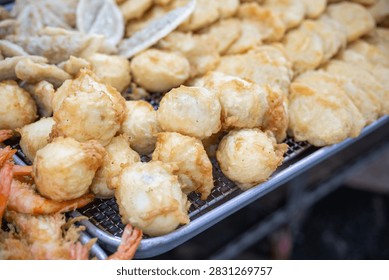 Full frame close up of crispy deep fried boiled eggs with assorted tempura at a street food stall in Korea.