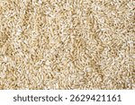 Full frame close up flat lay texture of brown rice for food and nutrition background. Healthy eating and cooking concept with copy space pattern of organic grains.