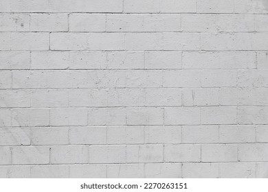Full frame close up on a cinder block wall painted in white.