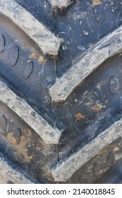 Full Frame Closeup Of A Huge Farm Tractor Tire With Ridges And Grips.