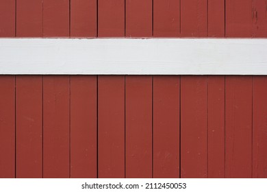 Full Frame Closeup Of A Red Barn With Wooden Siding.