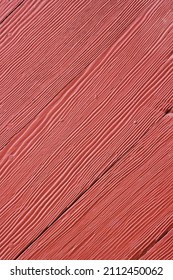 Full Frame Closeup Of A Red Barn With Wooden Siding.