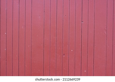 Full Frame Closeup Of A Red Barn With Wooden Siding.