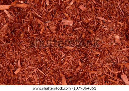 Full frame closeup of red mulch used for gardening and landscape decoration.