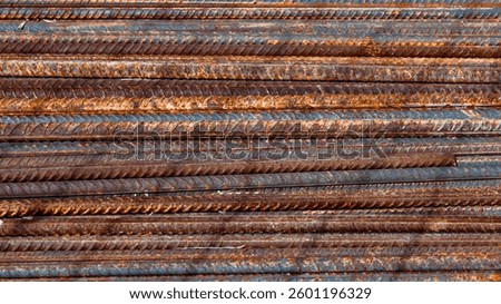 full frame close-up of a stack of rusty rebar reinforcing bars. often used in concrete and masonry construction to provide tensile strength abstract texture background