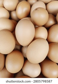 Full frame closeup texture of raw brown chicken eggs