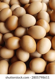 Full frame closeup texture of raw brown chicken eggs