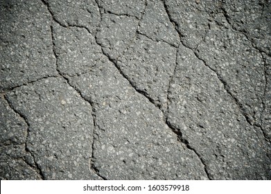 Full Frame Grunge Background Of Cracked Old Asphalt Pavement 