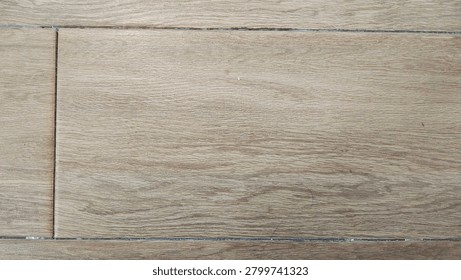 Full frame high-angle shot of durable ceramic tile flooring featuring a realistic light brown wood grain texture and grout lines, ideal for modern interior design backdrops.