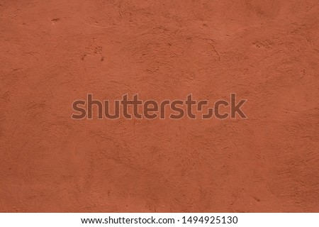Full frame image of textured stucco in bright terracotta color. High resolution abstract texture for 3d model, background, pattern, poster or collage