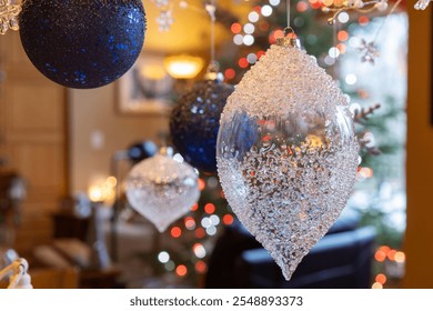 Full frame macro abstract texture background with defocused blue and transparent glass Christmas ornaments