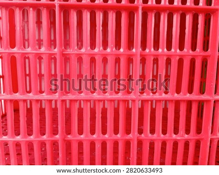 Full frame macro shot of red plastic crate slot pattern background