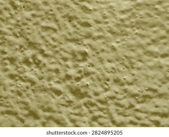 Full frame macro texture of bumpy yellow painted wall surface.
