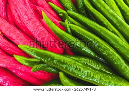 Full frame many green and red chilies for cooking Asian food. Herb and food ingredient. Chilli pepper. Pile of chillies spicy background texture. Fresh Thai chili pepper for spicy ingredient in food.