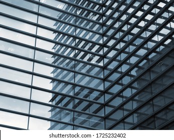 a full frame modern urban office architectural abstract with geometric shapes and buildings reflected in blue glass windows